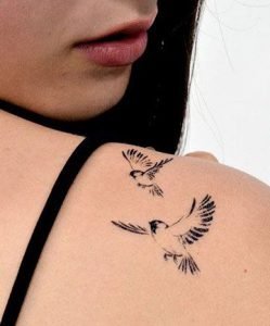 black bird and white bird tattoo