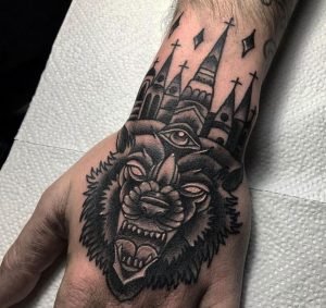 wolf skull hand tattoo